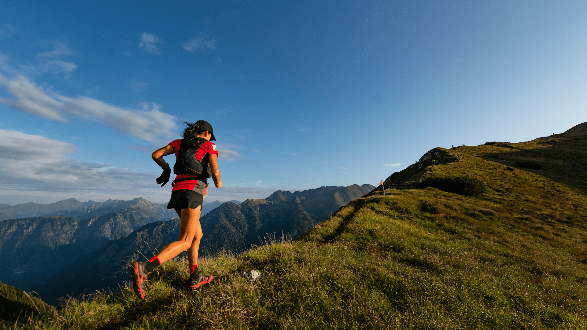 A trail runner climbing a mountain ridge